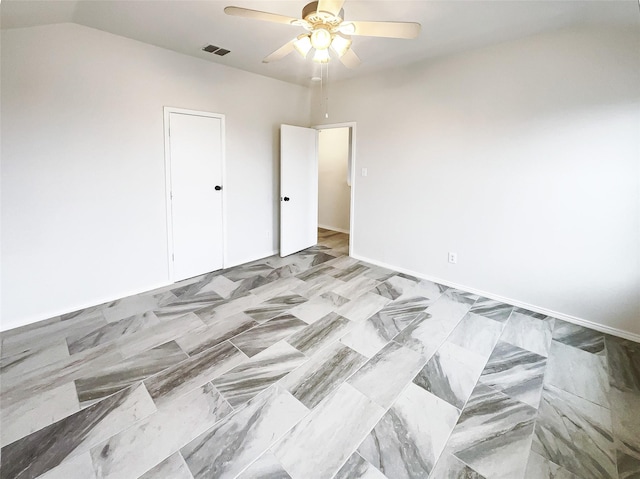 unfurnished room with vaulted ceiling, visible vents, and a ceiling fan