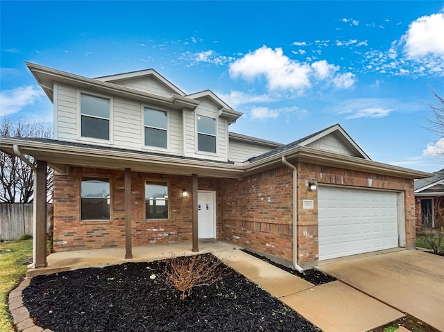 view of front of house with a garage, covered porch, brick siding, and driveway