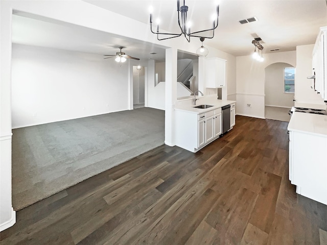 kitchen featuring dishwasher, open floor plan, light countertops, white cabinetry, and a sink