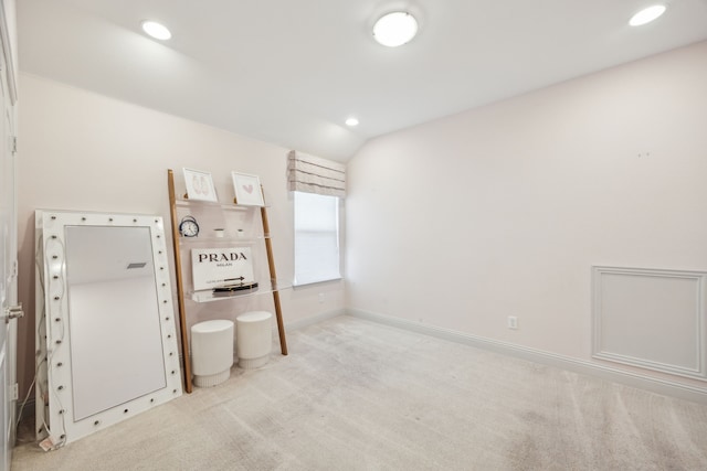 unfurnished bedroom with recessed lighting, baseboards, vaulted ceiling, and light colored carpet