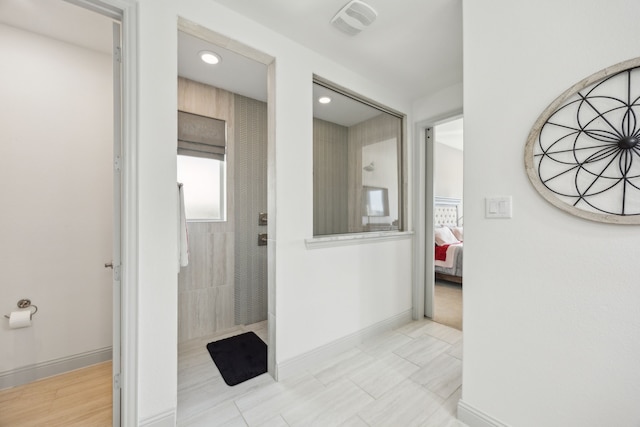 bathroom with ensuite bath, visible vents, baseboards, and a walk in shower