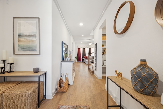 hallway featuring light wood-style floors, stairway, baseboards, and recessed lighting