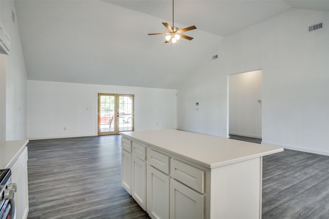 kitchen featuring french doors, visible vents, open floor plan, white cabinets, and a kitchen island