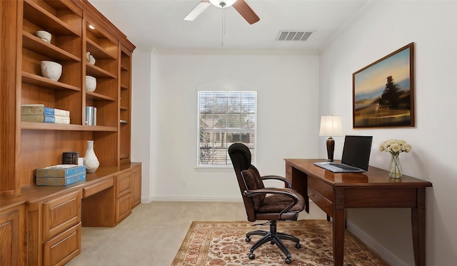 office area with crown molding, visible vents, built in study area, and light colored carpet