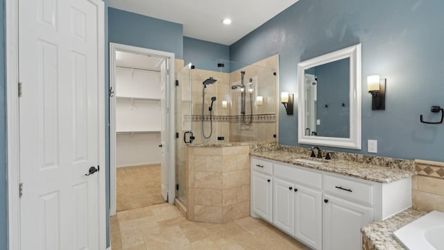 full bathroom featuring a stall shower and vanity