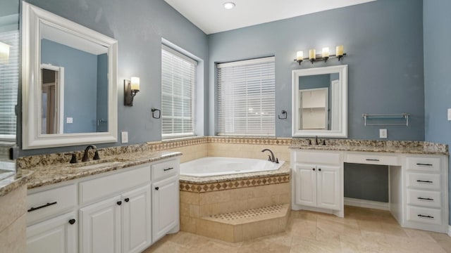 full bath featuring two vanities, a sink, a bath, and tile patterned floors