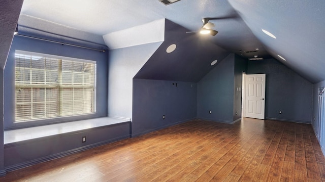 additional living space with ceiling fan, vaulted ceiling, baseboards, and wood finished floors