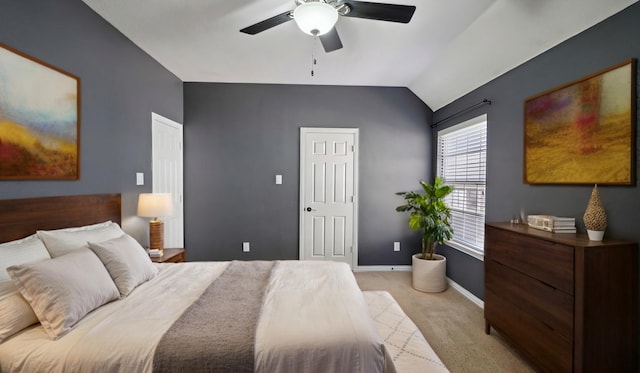 bedroom featuring vaulted ceiling, light carpet, a ceiling fan, and baseboards