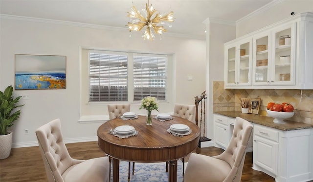 dining room featuring ornamental molding, dark wood-style flooring, a notable chandelier, and baseboards