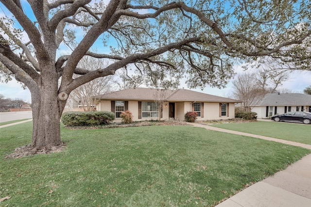 single story home featuring a front lawn and brick siding