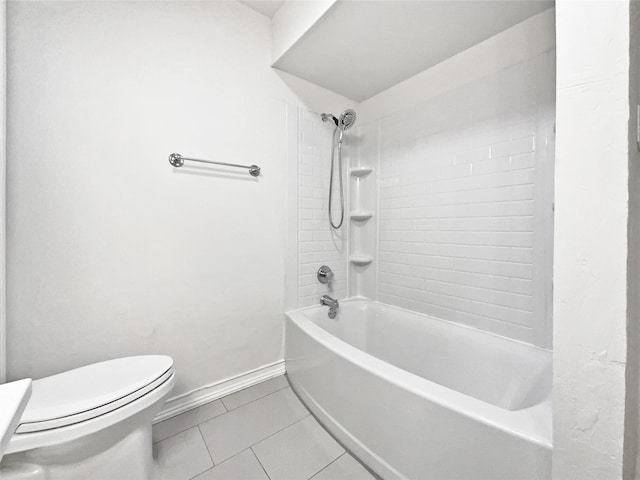 bathroom with toilet, bathtub / shower combination, baseboards, and tile patterned floors