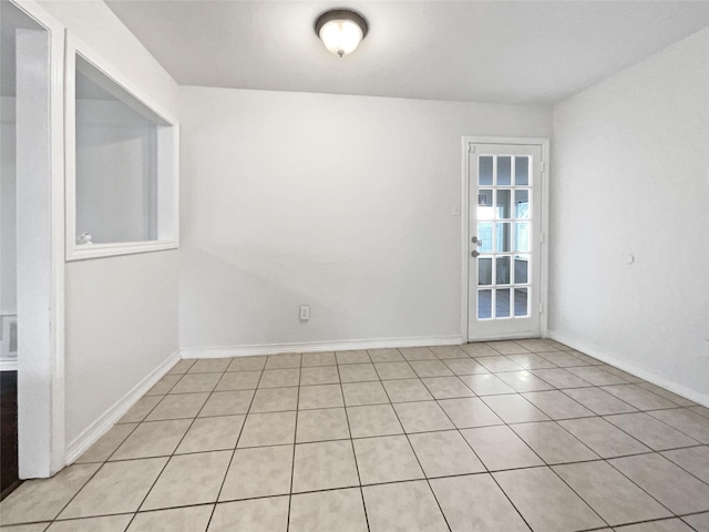 unfurnished room with baseboards