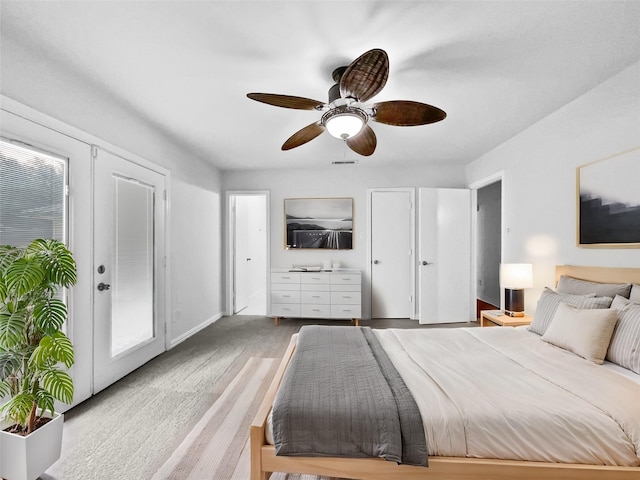 bedroom with ceiling fan, visible vents, and baseboards