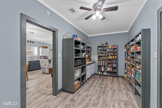 interior space featuring ceiling fan, a sink, and visible vents