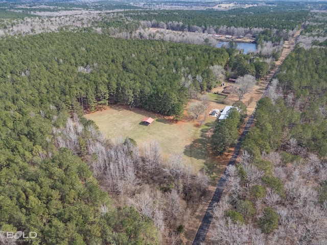 drone / aerial view with a water view and a wooded view