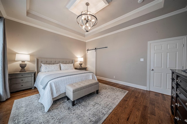 bedroom with a barn door, a tray ceiling, dark wood-type flooring, and a notable chandelier