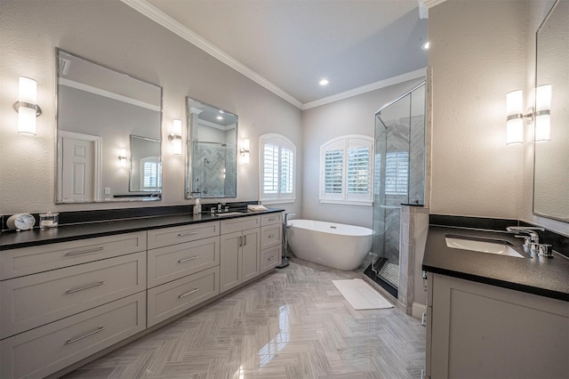 full bath featuring crown molding, a stall shower, and a sink