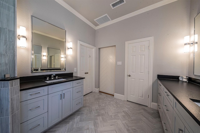 bathroom with baseboards, vanity, visible vents, and ornamental molding