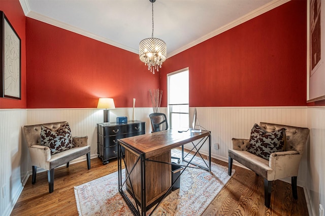 office space with crown molding, a chandelier, wood finished floors, and wainscoting