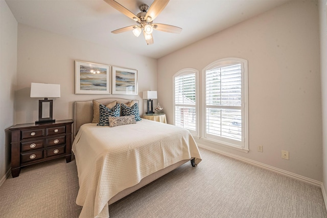 bedroom featuring baseboards, a ceiling fan, and light colored carpet