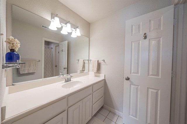 full bath with curtained shower, visible vents, vanity, baseboards, and tile patterned floors