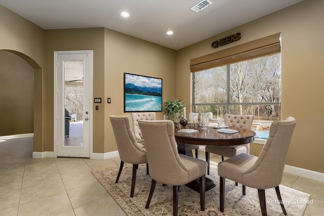 dining area with visible vents, baseboards, recessed lighting, light tile patterned flooring, and arched walkways