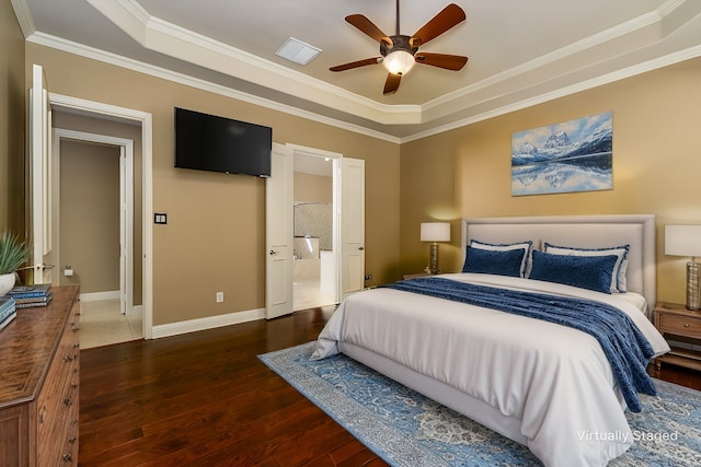 bedroom with a tray ceiling, ensuite bath, wood finished floors, crown molding, and baseboards