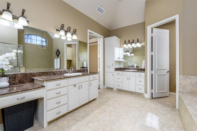 full bathroom featuring vaulted ceiling, two vanities, visible vents, and a sink