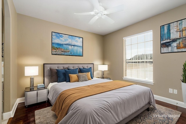 bedroom with baseboards, wood finished floors, and a ceiling fan