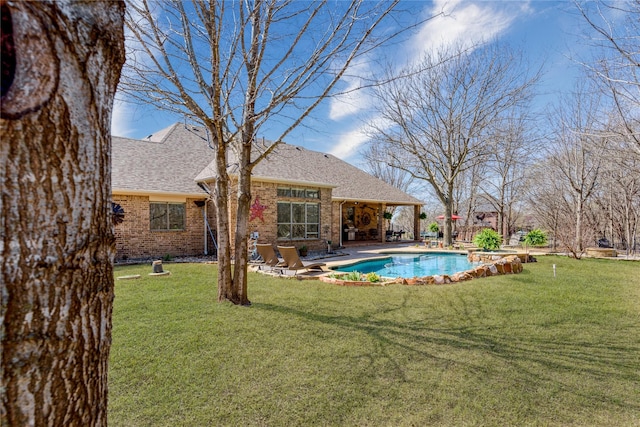 outdoor pool featuring a lawn and a patio