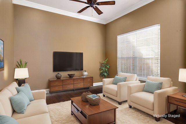 living room featuring crown molding, a ceiling fan, baseboards, and light wood finished floors