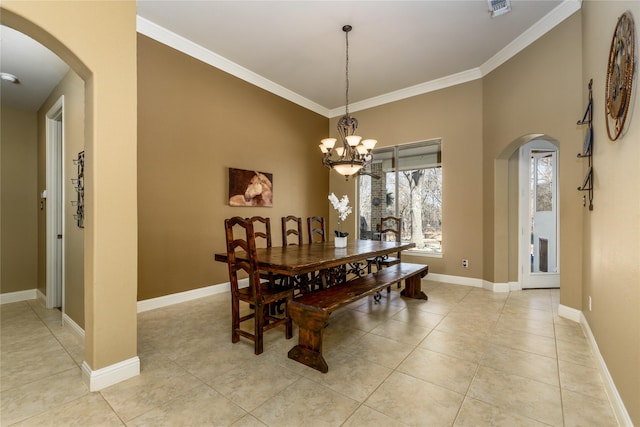 dining space featuring arched walkways, an inviting chandelier, crown molding, and baseboards