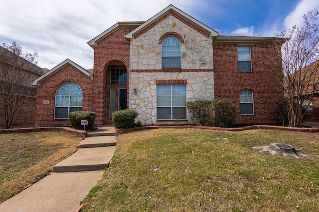 view of front facade with brick siding, stone siding, and a front yard