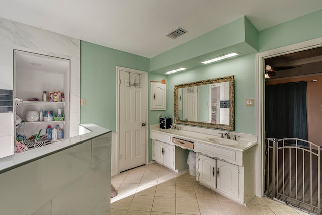 bathroom with double vanity, visible vents, a sink, and tile patterned floors