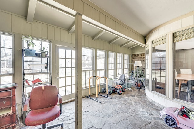 sunroom featuring beam ceiling