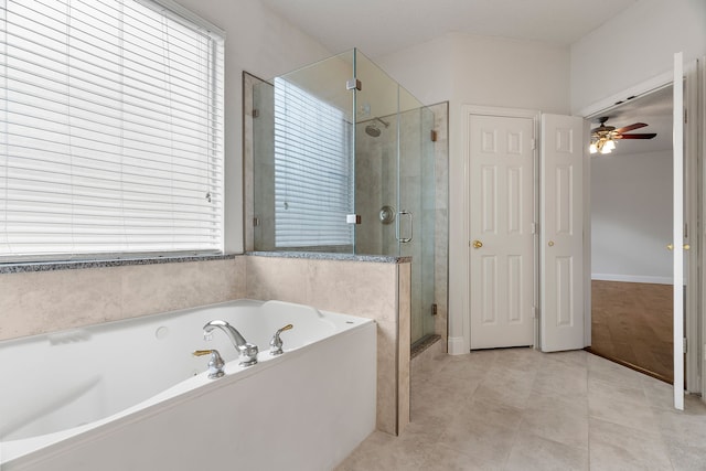 bathroom featuring tile patterned flooring, plenty of natural light, a shower stall, and a bath