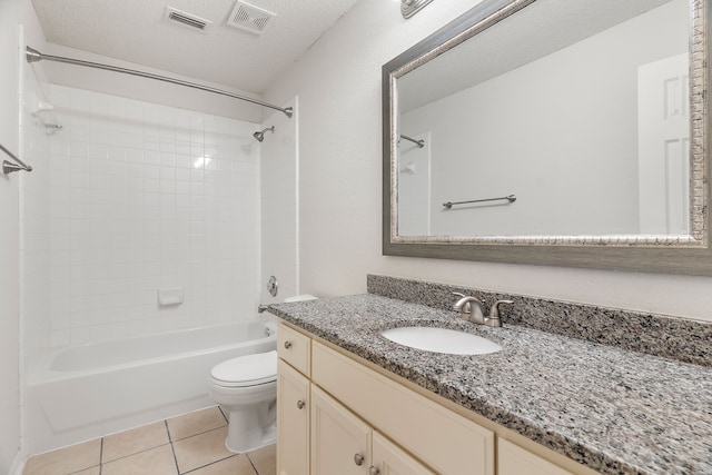 bathroom featuring tile patterned flooring, visible vents, a textured ceiling, and toilet