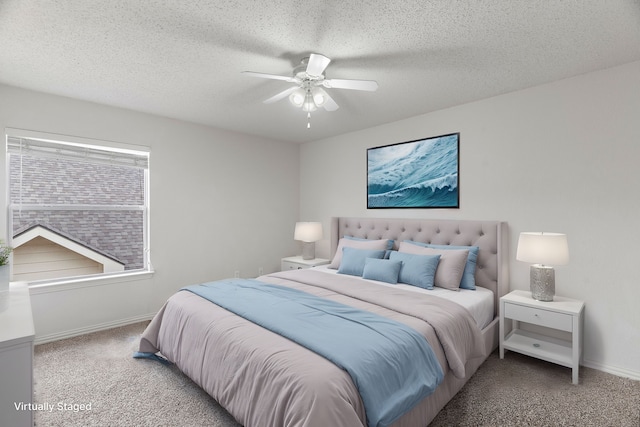 carpeted bedroom featuring a textured ceiling, a ceiling fan, and baseboards