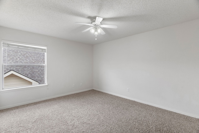 spare room with ceiling fan, carpet floors, a textured ceiling, and baseboards