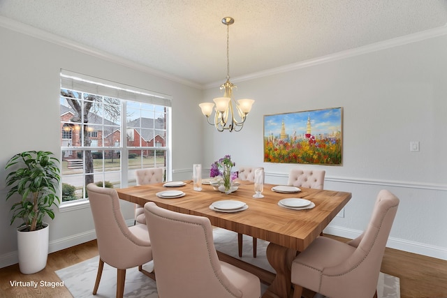 dining room with a chandelier, a textured ceiling, wood finished floors, and a wealth of natural light