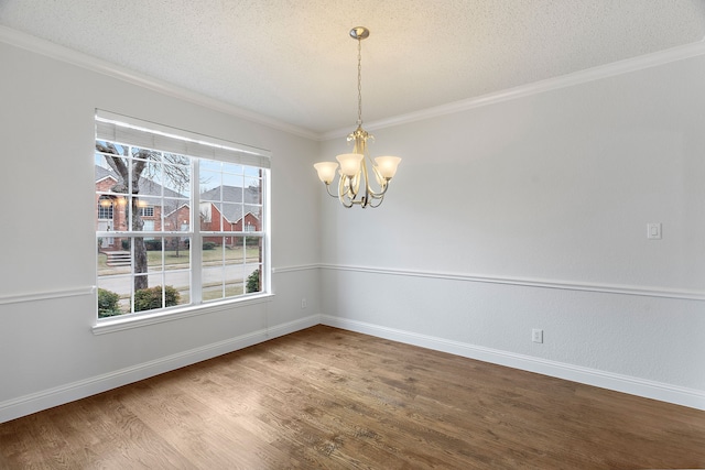 unfurnished room with a chandelier, a textured ceiling, wood finished floors, and a healthy amount of sunlight