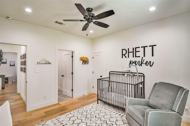 bedroom featuring baseboards, wood finished floors, and recessed lighting