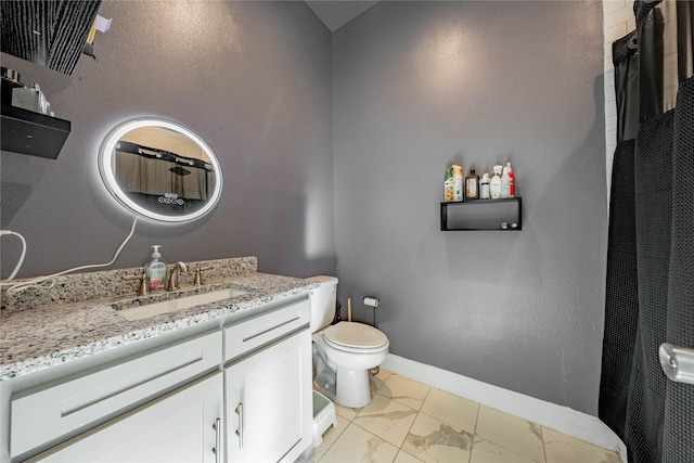 bathroom with toilet, marble finish floor, baseboards, and vanity