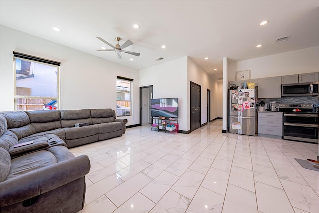 living area featuring recessed lighting, marble finish floor, and visible vents