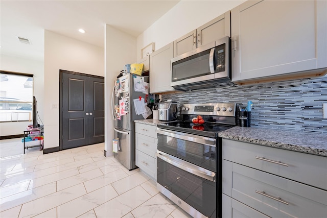 kitchen featuring appliances with stainless steel finishes, gray cabinets, marble finish floor, and light stone countertops