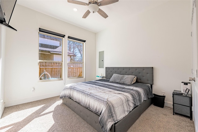 bedroom with light carpet, electric panel, baseboards, and a ceiling fan