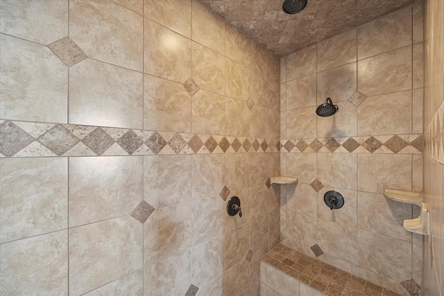 interior details featuring tiled shower