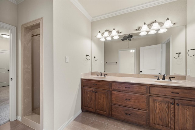 bathroom with double vanity, tile patterned flooring, a sink, and crown molding