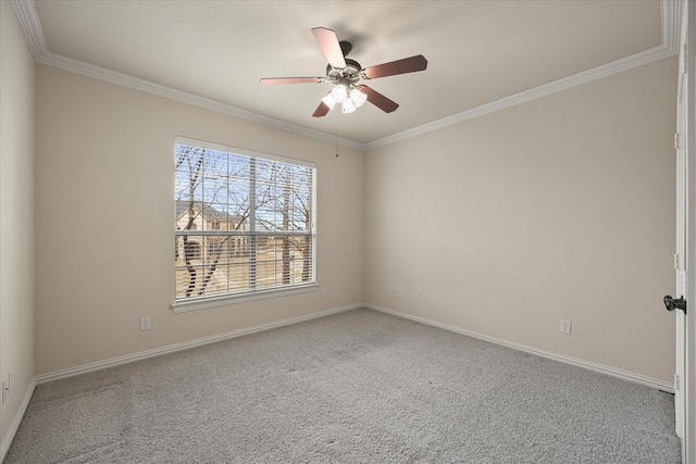 carpeted spare room featuring baseboards, a ceiling fan, and crown molding