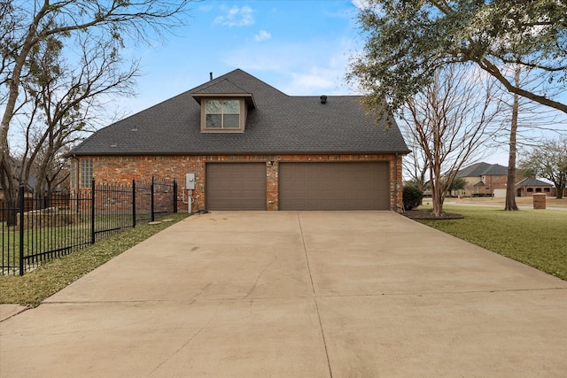 exterior space with driveway, brick siding, a shingled roof, and a yard